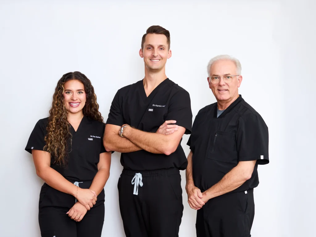Dr. Korbin Hally, Dr. Tim Rudd, and Dr. Ina Sukut at Coffee Creek Family Dentistry in Edmond, OK